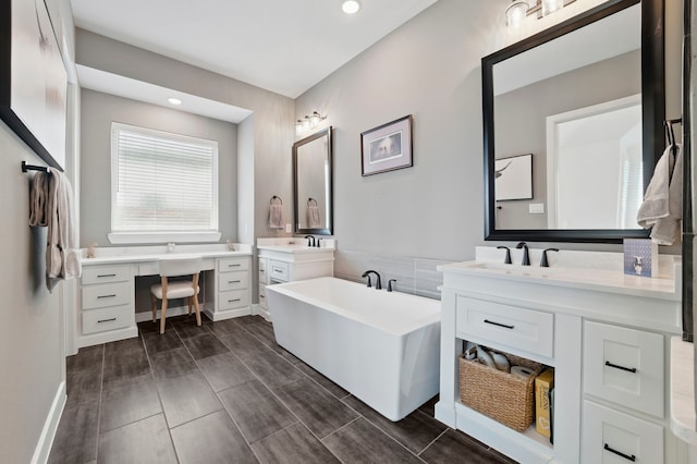 1301 Limestone Ridge Rd, Mansfield, TX 76063 - bathroom with a freestanding bath, two vanities, and recessed lighting