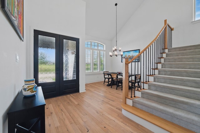 1301 Limestone Ridge Rd, Mansfield, TX 76063 - foyer featuring french doors, high vaulted ceiling, stairs, wood-type flooring, and a chandelier