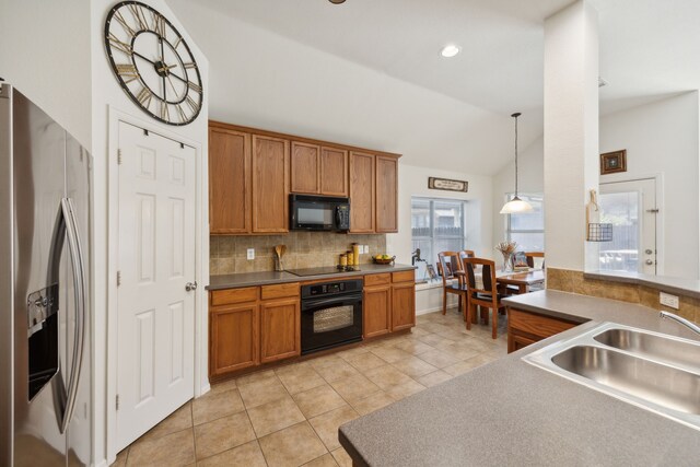 2748 Thorncreek Ln, Fort Worth, TX 76177 - kitchen featuring black appliances, a sink, brown cabinetry, decorative backsplash, and lofted ceiling