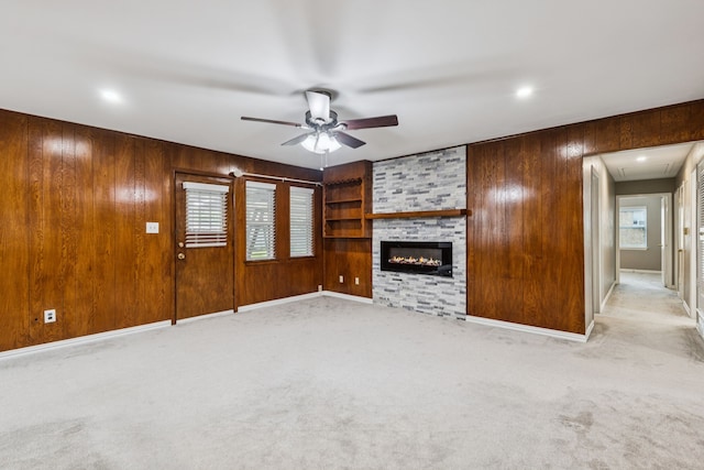 2140 Barbell Ln, Fort Worth, TX 76111 - unfurnished living room with ceiling fan, wood walls, attic access, carpet flooring, and a fireplace