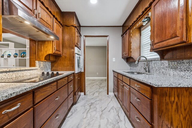 2140 Barbell Ln, Fort Worth, TX 76111 - kitchen with a sink, light marble finish floors, light stone countertops, wainscoting, and ornamental molding