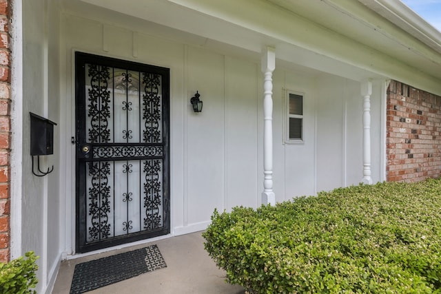 2140 Barbell Ln, Fort Worth, TX 76111 - property entrance with brick siding, board and batten siding, and covered porch