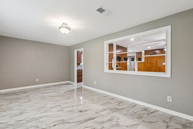 2140 Barbell Ln, Fort Worth, TX 76111 - empty room featuring light marble finish flooring and baseboards