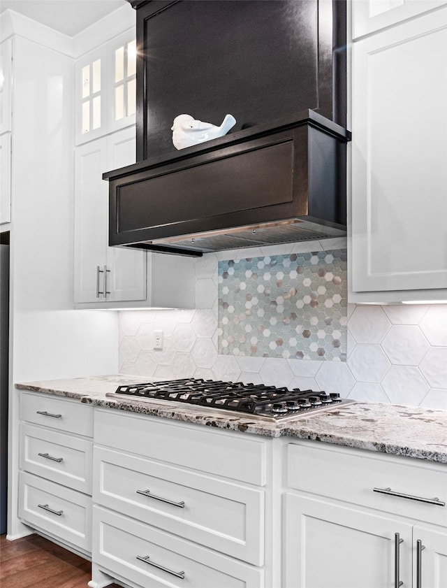9035 Shallow Cv, Tyler, TX 75703 - kitchen with backsplash, ventilation hood, stainless steel gas stovetop, and white cabinets