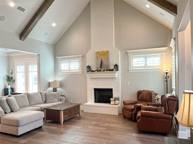 9035 Shallow Cv, Tyler, TX 75703 - living area with high vaulted ceiling, light wood-type flooring, beam ceiling, a fireplace, and plenty of natural light