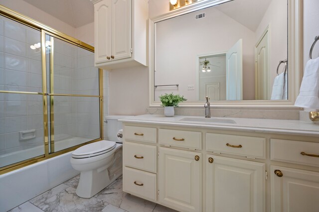 8005 Jefferson Cir, Colleyville, TX 76034 - bathroom featuring vanity, marble look tiles, enclosed tub / shower combo, toilet, and ceiling fan