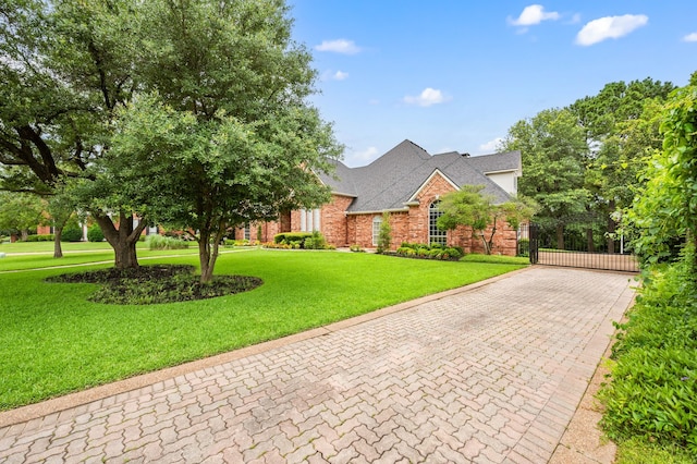 8005 Jefferson Cir, Colleyville, TX 76034 - view of front facade with decorative driveway, a front lawn, brick siding, and a gate