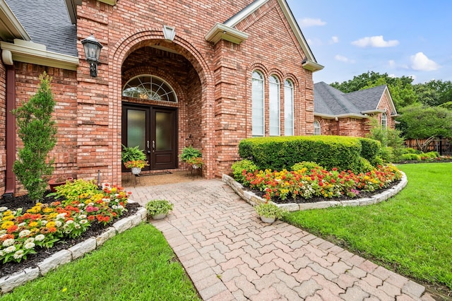 8005 Jefferson Cir, Colleyville, TX 76034 - view of exterior entry with brick siding, roof with shingles, and a lawn