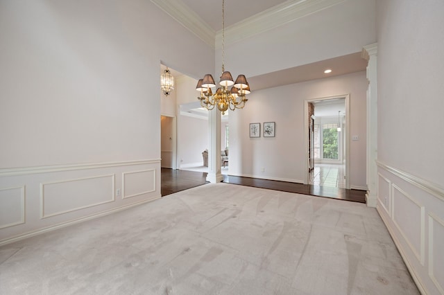 8005 Jefferson Cir, Colleyville, TX 76034 - unfurnished dining area featuring crown molding, a chandelier, carpet flooring, a decorative wall, and wainscoting