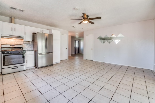 1709 Meadow Vly, Irving, TX 75060 - kitchen featuring appliances with stainless steel finishes, under cabinet range hood, a ceiling fan, decorative backsplash, and white cabinetry
