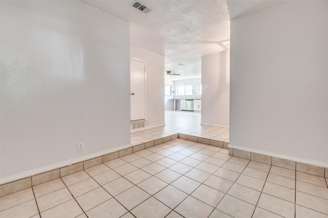 1709 Meadow Vly, Irving, TX 75060 - empty room featuring light tile patterned flooring, a textured ceiling, ceiling fan, and baseboards