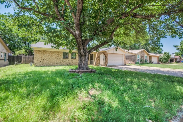 1709 Meadow Vly, Irving, TX 75060 - view of front of house featuring brick siding, an attached garage, driveway, and board and batten siding