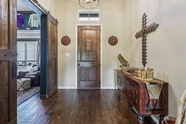114 Piper Pkwy, Waxahachie, TX 75165 - foyer featuring hardwood / wood-style floors, a barn door, and baseboards