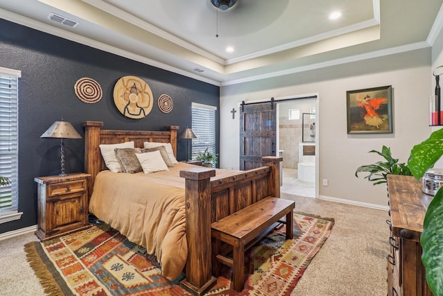 114 Piper Pkwy, Waxahachie, TX 75165 - carpeted bedroom with a barn door, a tray ceiling, baseboards, ensuite bath, and crown molding
