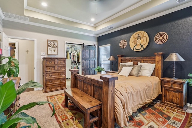 114 Piper Pkwy, Waxahachie, TX 75165 - carpeted bedroom featuring a tray ceiling, ornamental molding, a spacious closet, and a barn door