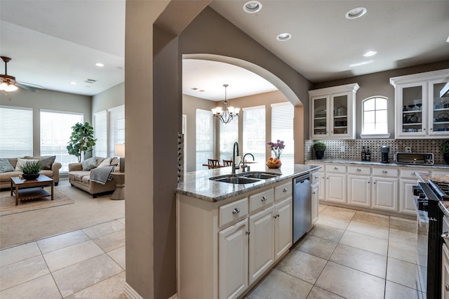 6312 Valley View Dr, Mckinney, TX 75071 - kitchen with a sink, appliances with stainless steel finishes, light tile patterned floors, ceiling fan, and light stone countertops