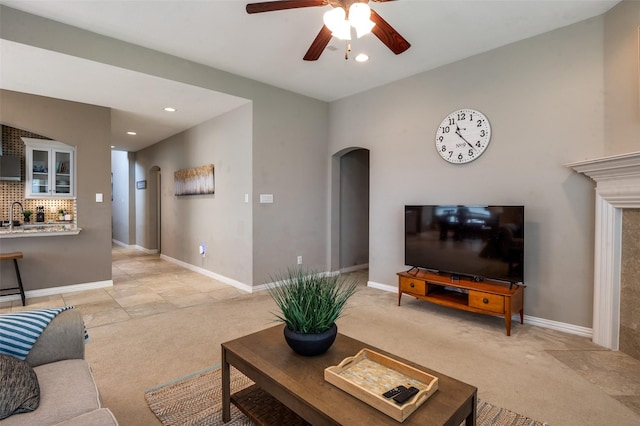 6312 Valley View Dr, Mckinney, TX 75071 - living area featuring light colored carpet, arched walkways, ceiling fan, recessed lighting, and baseboards