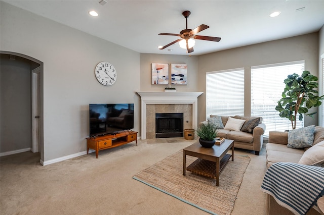 6312 Valley View Dr, Mckinney, TX 75071 - carpeted living area with a ceiling fan, arched walkways, a tile fireplace, baseboards, and recessed lighting
