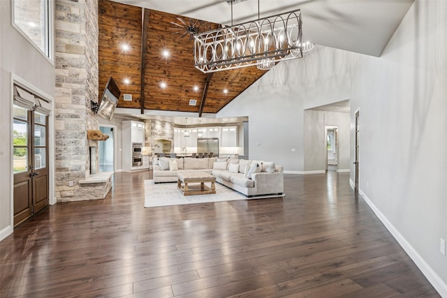 12877 Foutch Rd, Pilot Point, TX 76258 - living room featuring high vaulted ceiling, dark wood-style floors, a chandelier, baseboards, and wood ceiling