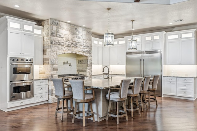 12877 Foutch Rd, Pilot Point, TX 76258 - kitchen with stainless steel appliances, tasteful backsplash, dark wood-style floors, white cabinetry, and recessed lighting