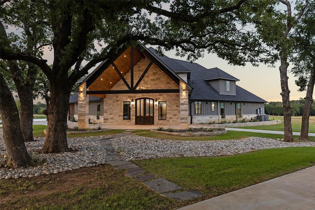 12877 Foutch Rd, Pilot Point, TX 76258 - view of front of property featuring stone siding, a yard, and board and batten siding