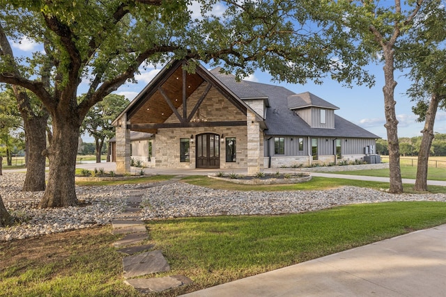 12877 Foutch Rd, Pilot Point, TX 76258 - view of front of home with stone siding, board and batten siding, and a front lawn