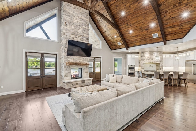 12877 Foutch Rd, Pilot Point, TX 76258 - living area featuring high vaulted ceiling, wood ceiling with exposed beams, baseboards, dark wood-style flooring, and plenty of natural light