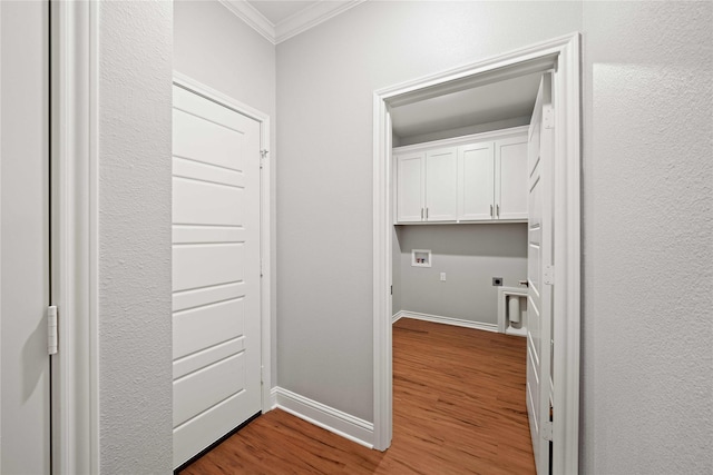 120 Hay Meadow Dr, Winona, TX 75792 - washroom featuring ornamental molding, washer hookup, hookup for an electric dryer, wood finished floors, and cabinet space