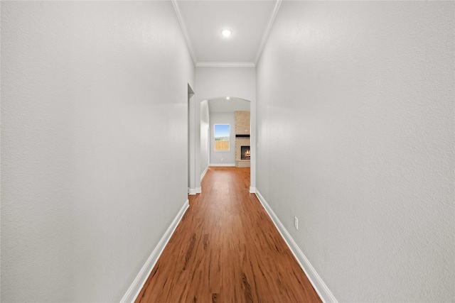 120 Hay Meadow Dr, Winona, TX 75792 - hall featuring arched walkways, crown molding, wood finished floors, and baseboards