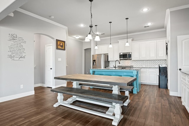 1207 Mae St, Anna, TX 75409 - dining room featuring arched walkways, recessed lighting, ornamental molding, dark wood-style flooring, and baseboards