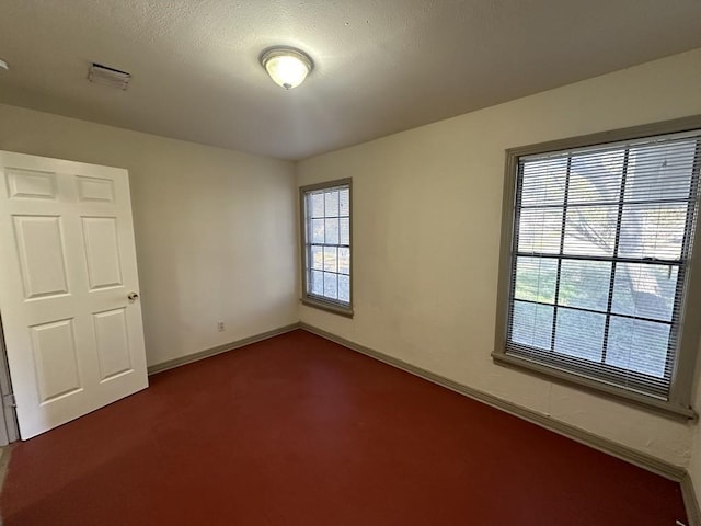 1517 Maple Dr, Garland, TX 75042 - empty room featuring dark colored carpet and baseboards
