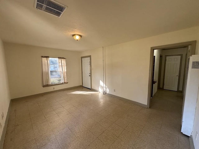 1517 Maple Dr, Garland, TX 75042 - empty room with a heating unit, baseboards, and tile patterned floors