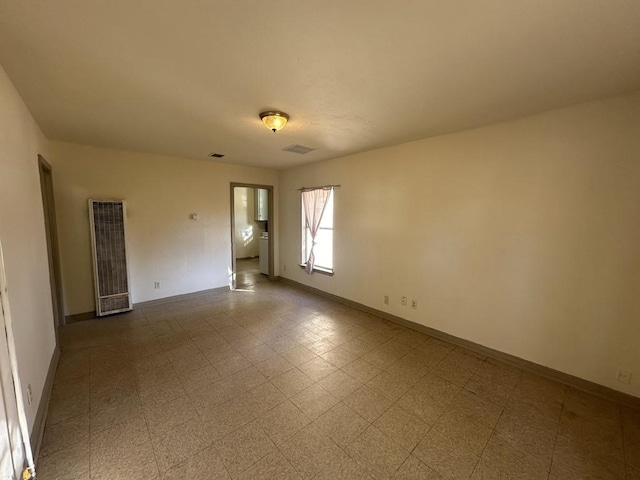 1517 Maple Dr, Garland, TX 75042 - unfurnished room with a heating unit and baseboards
