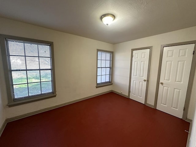 1517 Maple Dr, Garland, TX 75042 - unfurnished bedroom featuring baseboards and dark carpet