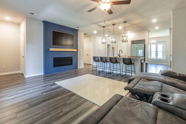 7020 Llano Dr, Waco, TX 76633 - living area with ceiling fan, baseboards, dark wood-style floors, a large fireplace, and recessed lighting