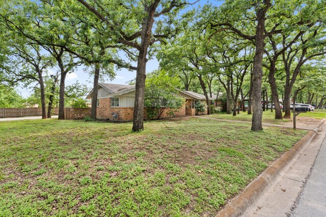 521 Brookview Dr, Hurst, TX 76054 - view of front facade with brick siding, central air condition unit, and a front lawn