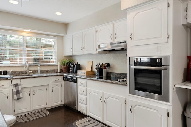 521 Brookview Dr, Hurst, TX 76054 - kitchen featuring appliances with stainless steel finishes, under cabinet range hood, a sink, white cabinets, and dark wood finished floors