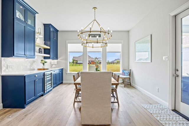 3201 Dovehill Dr, Northlake, TX 76247 - dining space with wine cooler, a chandelier, light wood finished floors, and baseboards