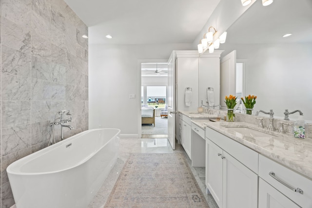 3201 Dovehill Dr, Northlake, TX 76247 - ensuite bathroom featuring double vanity, a freestanding bath, ceiling fan, marble finish floors, and recessed lighting