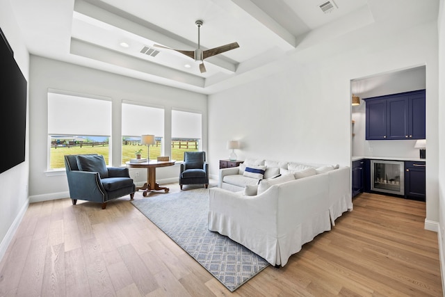 3201 Dovehill Dr, Northlake, TX 76247 - living area with wine cooler, light wood-type flooring, baseboards, a ceiling fan, and beam ceiling