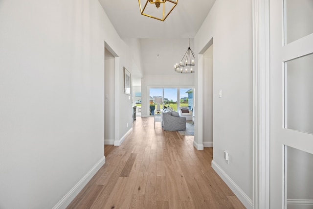 3201 Dovehill Dr, Northlake, TX 76247 - corridor featuring a chandelier, light wood-type flooring, and baseboards