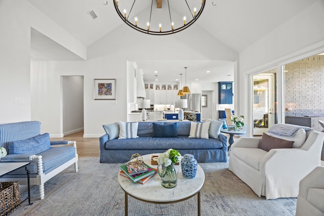 3201 Dovehill Dr, Northlake, TX 76247 - living room featuring a chandelier, high vaulted ceiling, light wood-type flooring, and baseboards