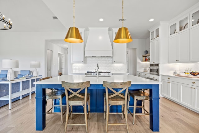 3201 Dovehill Dr, Northlake, TX 76247 - kitchen featuring custom exhaust hood, backsplash, a sink, light countertops, and recessed lighting