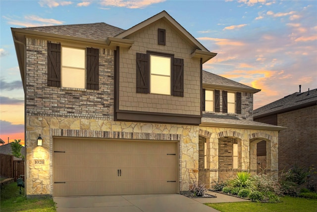 1028 W Dr, Aubrey, TX 76227 - view of front of property featuring a garage, stone siding, concrete driveway, and a shingled roof