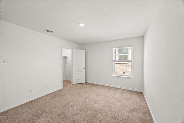 1028 W Dr, Aubrey, TX 76227 - unfurnished bedroom with light colored carpet, baseboards, and a walk in closet