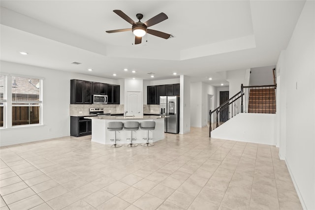 1028 W Dr, Aubrey, TX 76227 - kitchen with appliances with stainless steel finishes, dark cabinetry, tasteful backsplash, recessed lighting, and ceiling fan