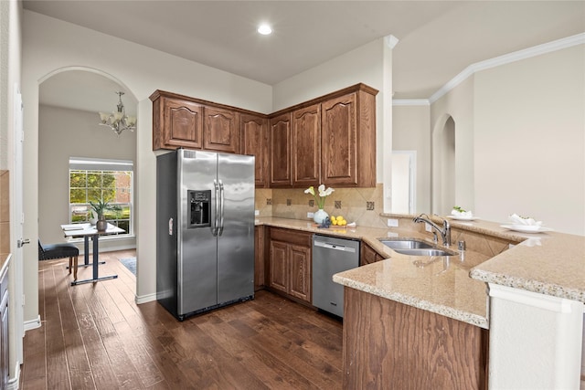 1825 Sanderlain Ln, Allen, TX 75002 - kitchen with stainless steel appliances, a sink, arched walkways, dark wood-style flooring, and recessed lighting