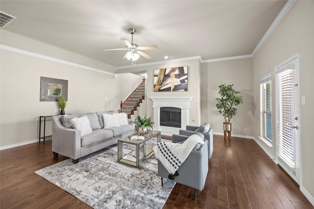 1825 Sanderlain Ln, Allen, TX 75002 - living room with ceiling fan, ornamental molding, dark wood-type flooring, baseboards, and a fireplace with raised hearth