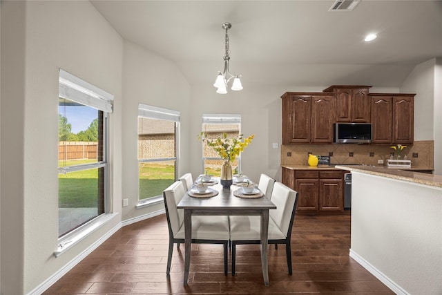 1825 Sanderlain Ln, Allen, TX 75002 - dining area featuring lofted ceiling, dark wood finished floors, plenty of natural light, a chandelier, and recessed lighting