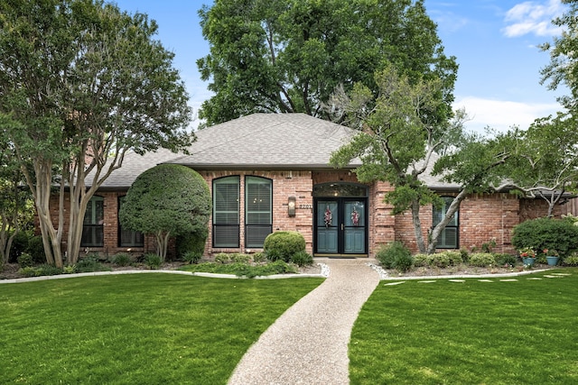 5701 Buffridge Trl, Dallas, TX 75252 - view of front of home featuring a front yard, brick siding, and a shingled roof